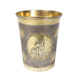 A Russian silver gilt beaker, Moscow 1738, of tapering form decorated three reserves,