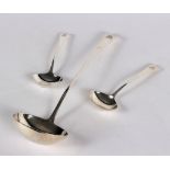 A George III silver soup ladle, R C, London 1806, and a pair of sauce ladles,