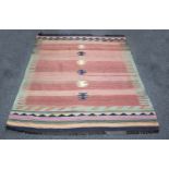 A Navajo style rug, worked with six black and white motifs to a central red ground,