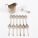 A set of twelve silver coffee spoons and the matching tongs, 1924 and a Georgian silver jug,