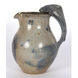 Toff Milway (British, born 1949)/Blue salt glazed jug/with fish handle, signed to base,