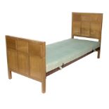 Harry Davoll (British 1876-1963)/Cotswold School oak single bed/with panelled headboard and