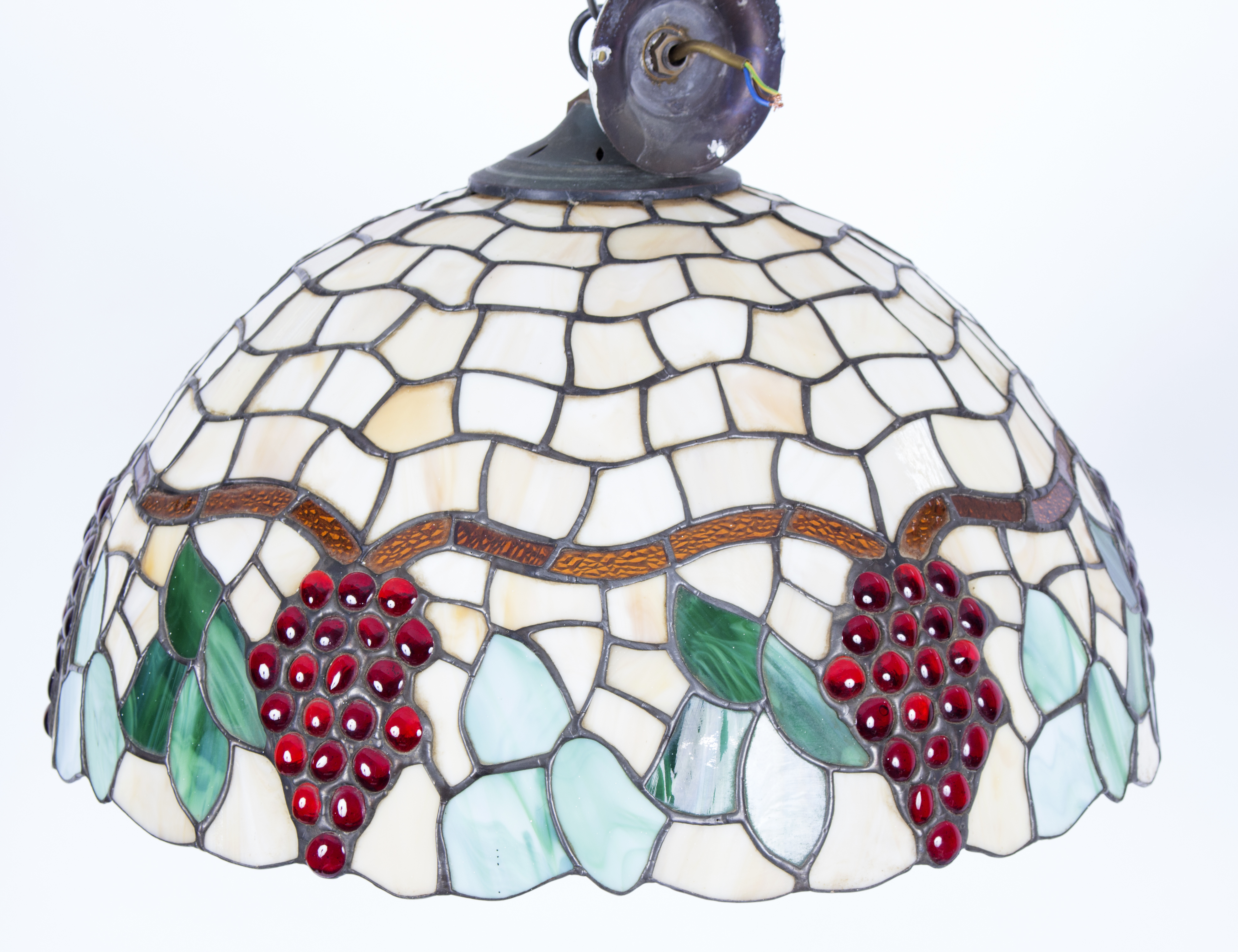 A Tiffany style pendant light fitting, the lead lined circular shade depicting fruiting vines,