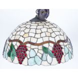 A Tiffany style pendant light fitting, the lead lined circular shade depicting fruiting vines,