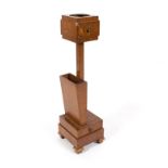 An Art Deco oak smoking stand on a square base fitted a drawer to upper and lower section,