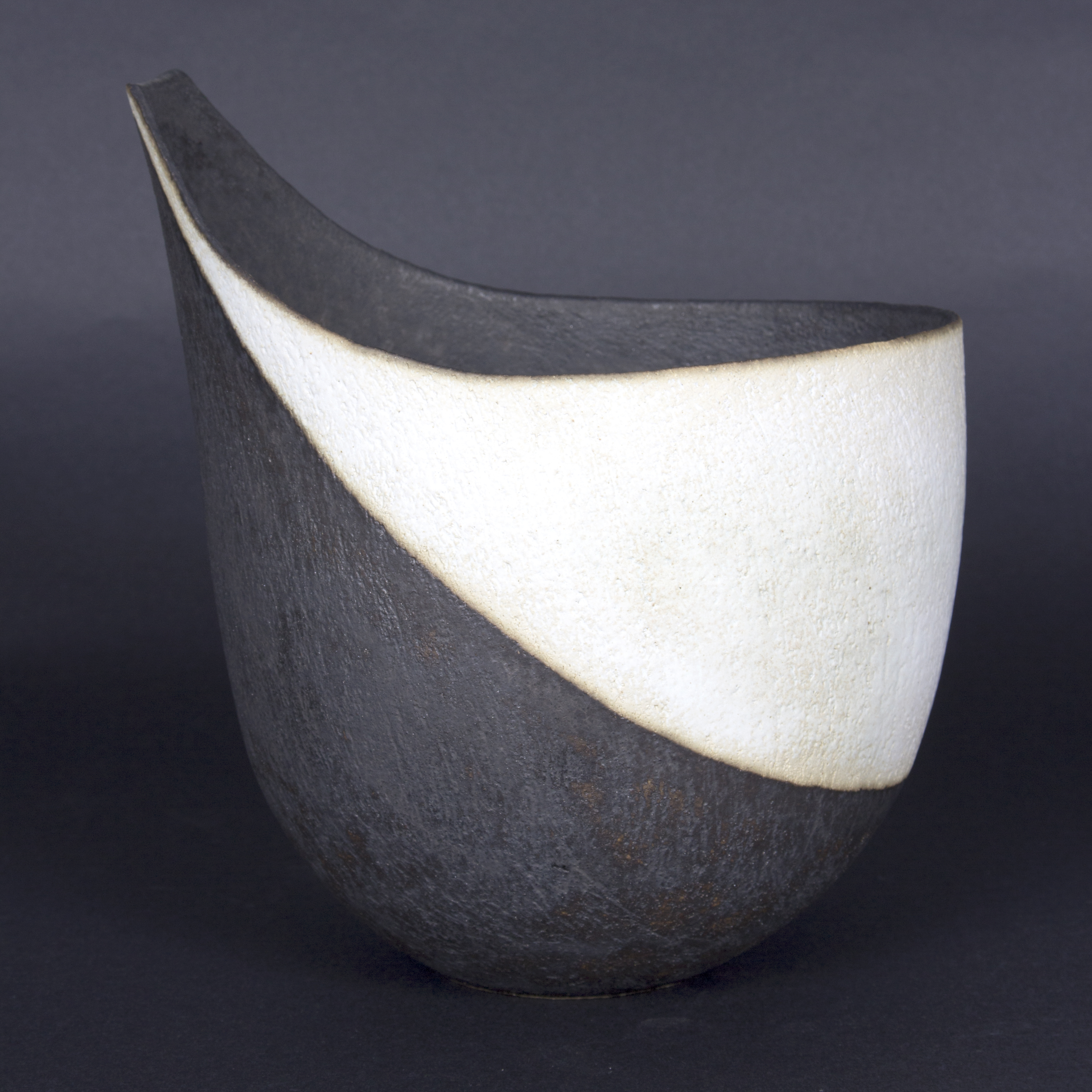 John Ward (British, born 1938)/Stoneware tailed bowl, in a matt black and white glaze,