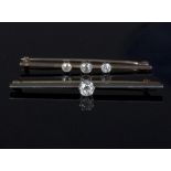 A diamond set bar brooch, the single old cut diamond approximately 0.