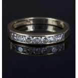 A diamond half eternity ring, set seven round brilliant cut diamonds to a 18ct gold mount,