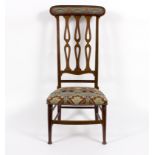 An Arts and Crafts chair, retailed by P E Gane Ltd, Bristol, with tall pierced and inlaid back,