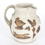 Martin Homer/Stoneware jug/applied with animals and flowers in brown to cream glazed ground, signed,