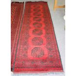 An Afghan runner, 290cm x 82cm and a Bokhara runner,