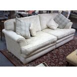 A large upholstered sofa, fitted loose seats and back cushions,