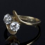 A diamond crossover ring, set two old cut diamonds, each measuring approximately 0.