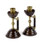 Christopher Dresser for Benham & Froud/Pair of Arts and Crafts brass and copper candlesticks,