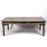 An Indian teak table from Rajasthan, with five plank studded top on turned legs,