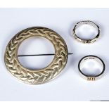 A Celtic circular silver brooch by Robert Allison and two silver and gilt rings/Provenance: Celia