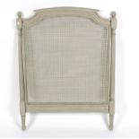 An OKA caned single headboard, painted grey,