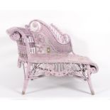 A painted wicker chaise longue, painted in pale purple, scrolling back,