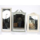 Three painted wall mirrors, one with carved foliate surmount,