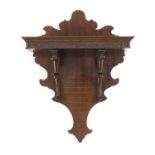A Victorian mahogany wall bracket, on scroll supports to a shaped backplate, 38.