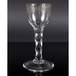 An English wine glass, circa 1770, the bowl engraved with a floral band on a faceted stem, 13.