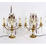A pair of four-light table lights, hung prismatic glass drops with gilt metal mounts,
