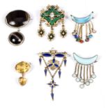 A group of six pendant brooches to include a gem set yellow metal mounted example,