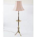 A brass and copper telescopic standard lamp, the stem with circular tray on a tripod base,