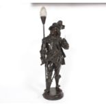 A figural table light, the bronzed metal cavalier support holding a sword, on a circular base,