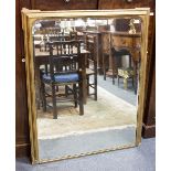 A giltwood overmantel mirror with moulded surround,