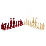 A mid 19th Century natural and red stained bone chess set, turned and carved,