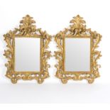 A pair of Rococo style gilt framed mirrors with elaborately scrolling frames, the plates 39.