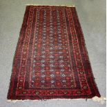 A Shiraz rug, with all over geometric design on a red ground,