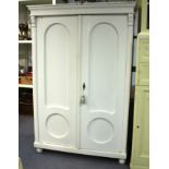 A Victorian painted pine wardrobe with panelled doors,