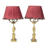 A pair of Louis XVI style ormolu table lamps with cherub bases on plinths,