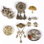 A peridot set filigree brooch to an unmarked yellow metal mount and a small group of white and gilt