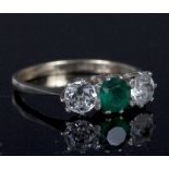 A three-stone dress ring set colourless and green paste to a 9ct gold and silver mount,