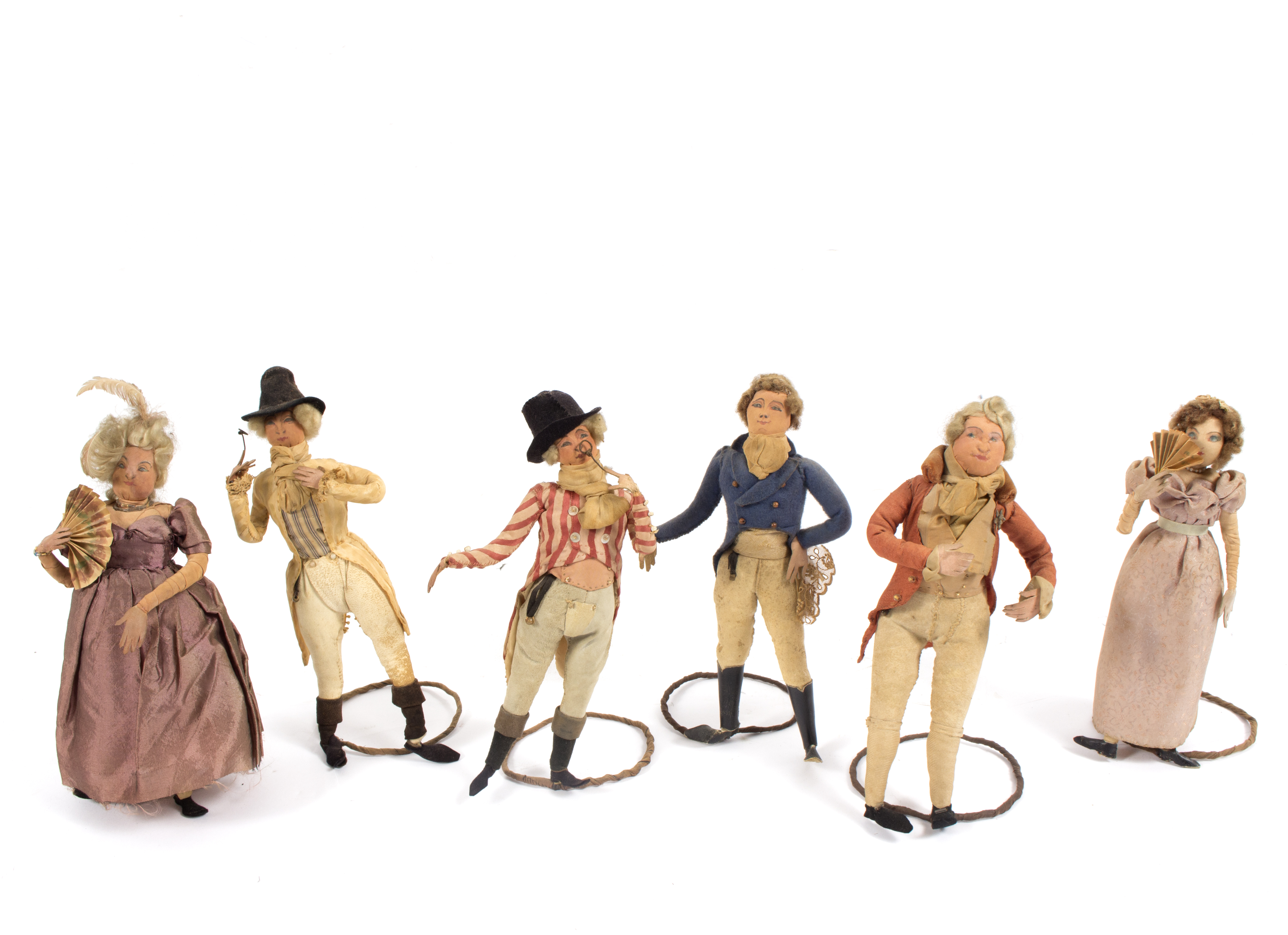 A group of six Regency dolls, with overstuffed kid leather bodies and silk dress, on wire stands,