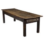 An 18th Century oak farmhouse table, the triple plank top on square chamfered legs,