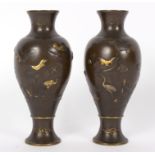 A pair of Japanese bronze vases, each of baluster form decorated birds and foliage,
