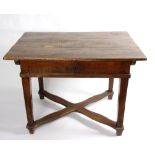 An oak table with sliding top and cross stretcher