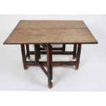 A rectangular elm two-flap gateleg table fitted a drawer to one end,