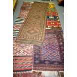 A group of various rugs to include a geometric red, navy and yellow example,