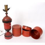 A red and black painted toleware lamp and two papier-maché circular Eastern boxes