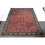 An Indian rug, decorated floral motifs to a mauve ground within a multifield border,