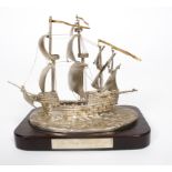 A silver model of the Mary Rose, Birmingham 1982, on a wooden plinth,