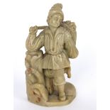 A Chinese carved soapstone figure depicting a European grape picker,