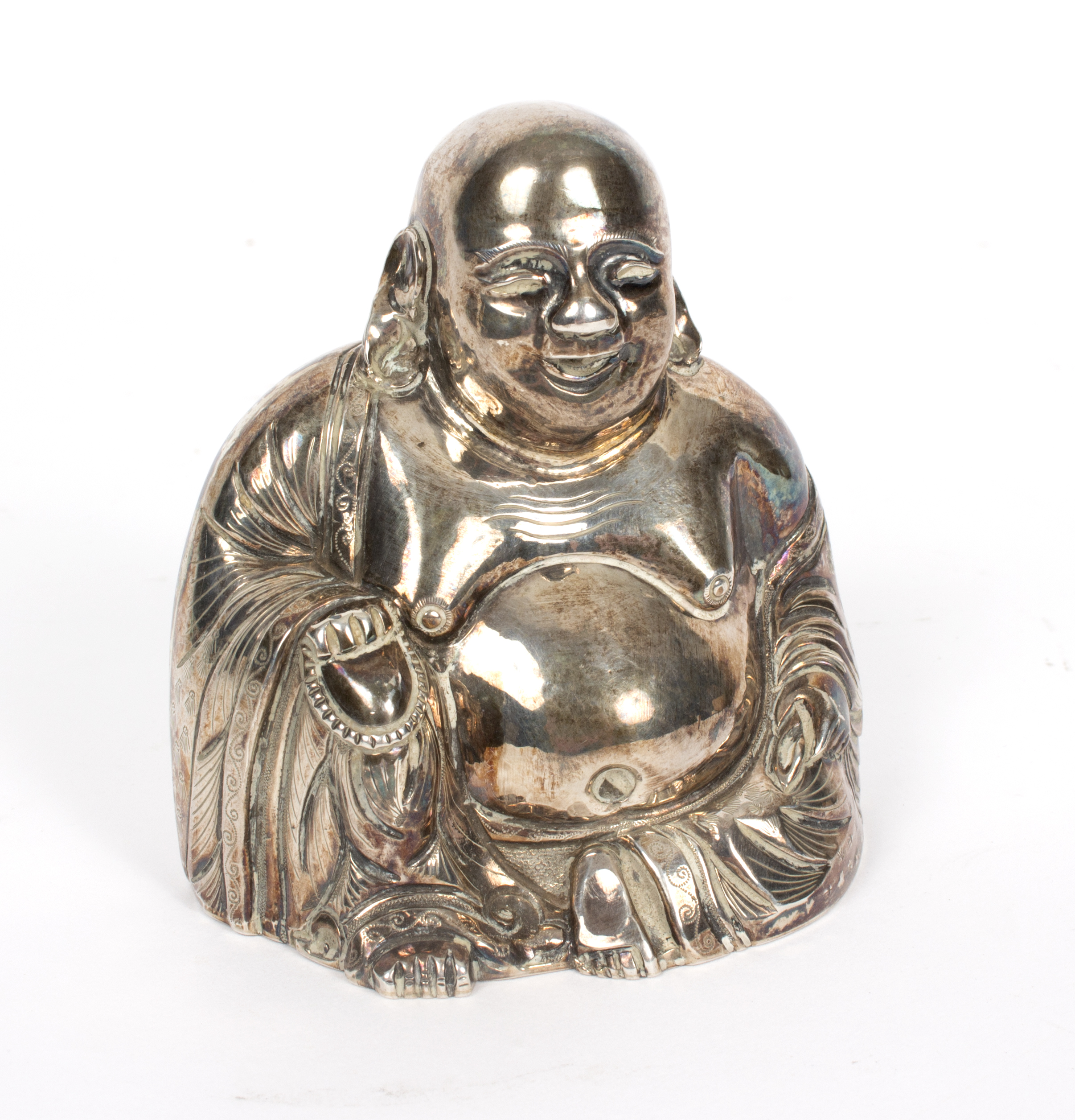 A white metal figure of Buddha, seated his hand resting on his knee,