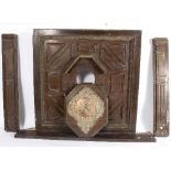 A 19th Century panelled oak overmantel fitted a central clock with copper chapter ring,