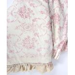 A pair of floral chintz curtains, decorated in pale pink to a cream ground,